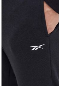 Reebok spodnie męskie kolor czarny gładkie. Kolor: czarny. Materiał: włókno, dzianina, materiał. Wzór: gładki #3