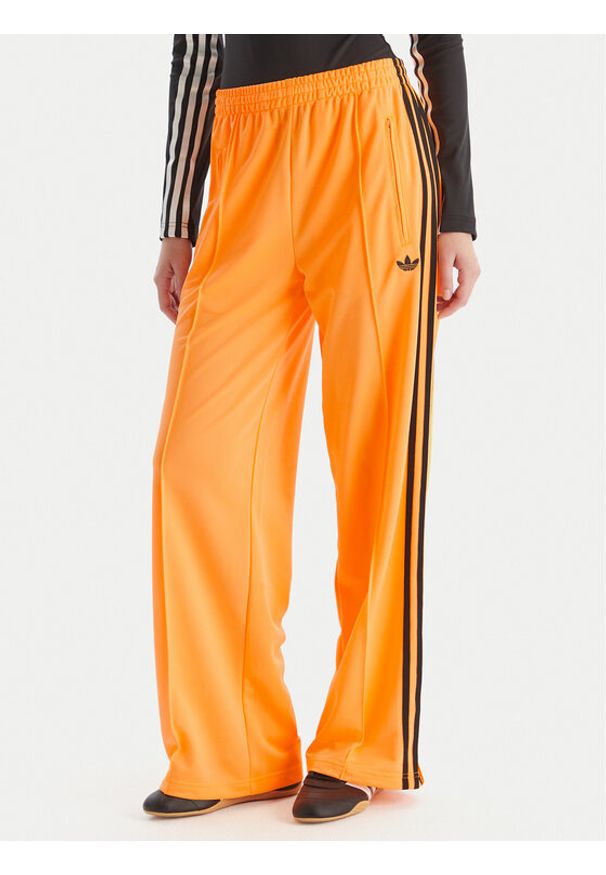 Adidas - adidas Spodnie dresowe adicolor Classic Firebird JY2694 Żółty Loose Fit. Kolor: żółty. Materiał: syntetyk