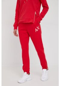 Armani Exchange spodnie dresowe bawełniane damskie kolor czerwony z nadrukiem. Kolor: czerwony. Materiał: dresówka, bawełna. Wzór: nadruk