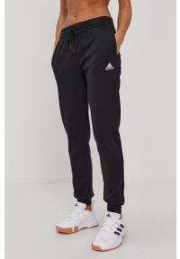 Adidas - adidas Spodnie damskie kolor czarny gładkie. Kolor: czarny. Materiał: bawełna. Wzór: gładki