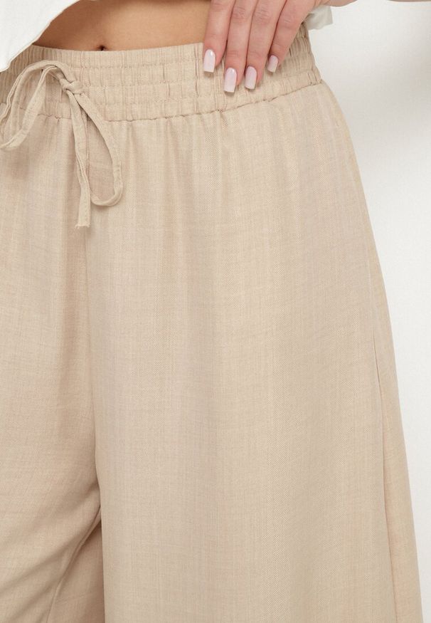 Born2be - Beżowe Spodnie o Szerokim Kroju z Wysokim Stanem i Wiązaniem Telarieta. Okazja: na co dzień. Stan: podwyższony. Kolor: beżowy. Materiał: len. Styl: klasyczny, casual, elegancki