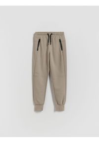 Reserved - Bawełniane spodnie jogger - beżowy. Kolor: beżowy. Materiał: bawełna